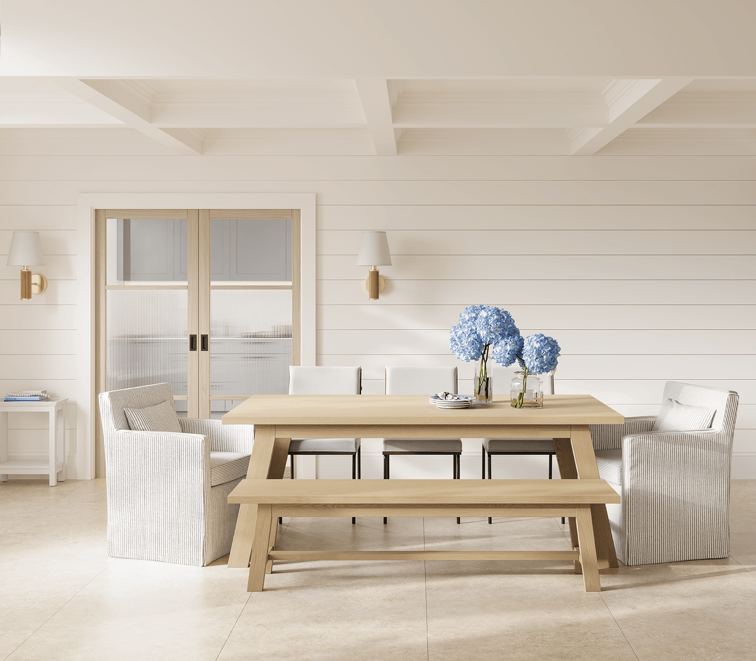 Dining room with wooden table and chairs, and a vase of flowers.