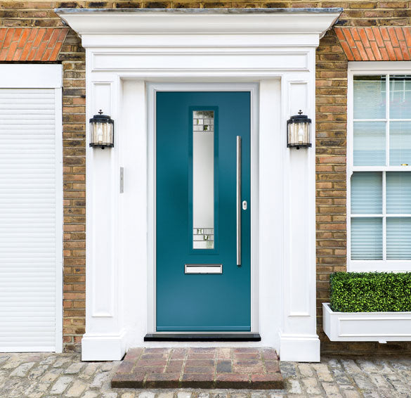 Teal front door with white frame on a brick house