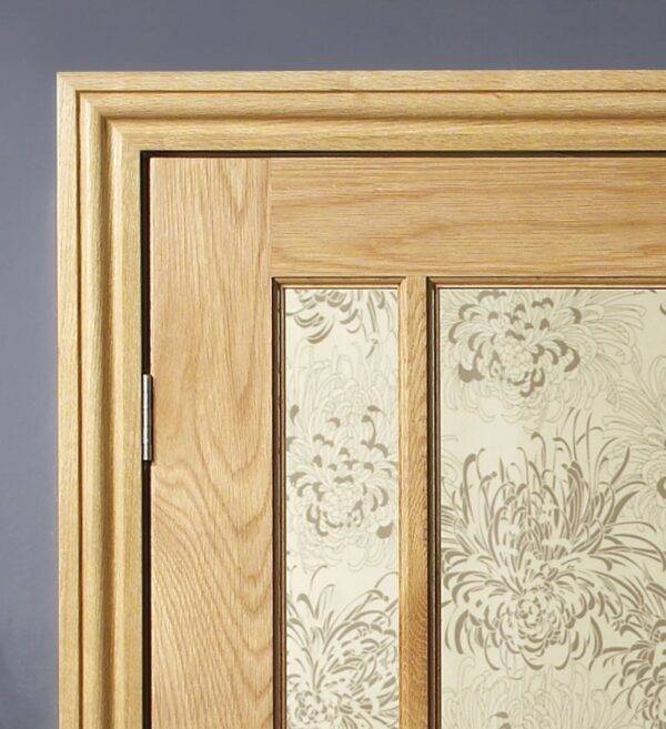 Wooden door with floral glass panels on a gray background