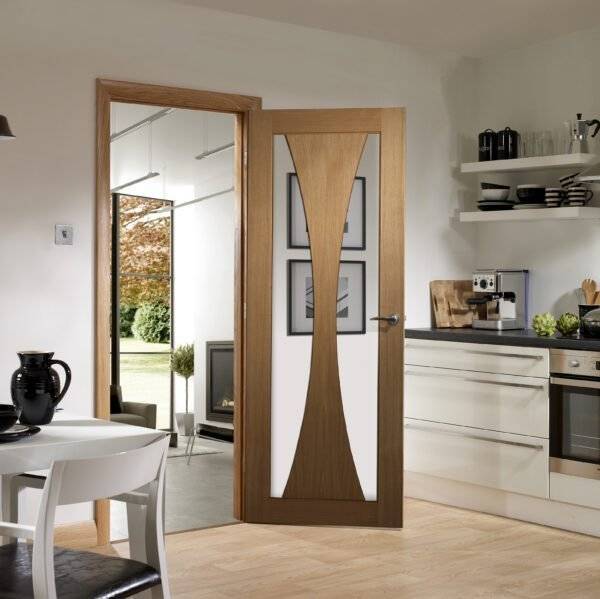 Wooden interior door with glass panel in a modern kitchen setting