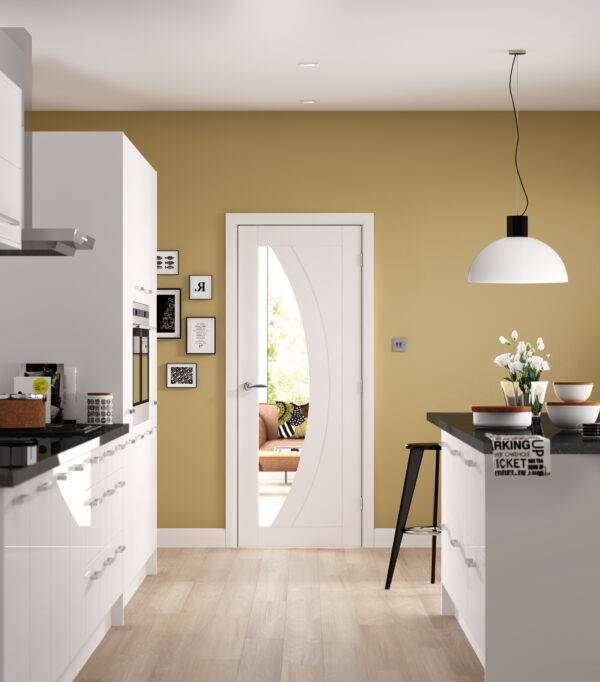 Modern kitchen with yellow walls, white cabinets, and a black countertop.