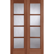 Wooden door with glass panels on a green background