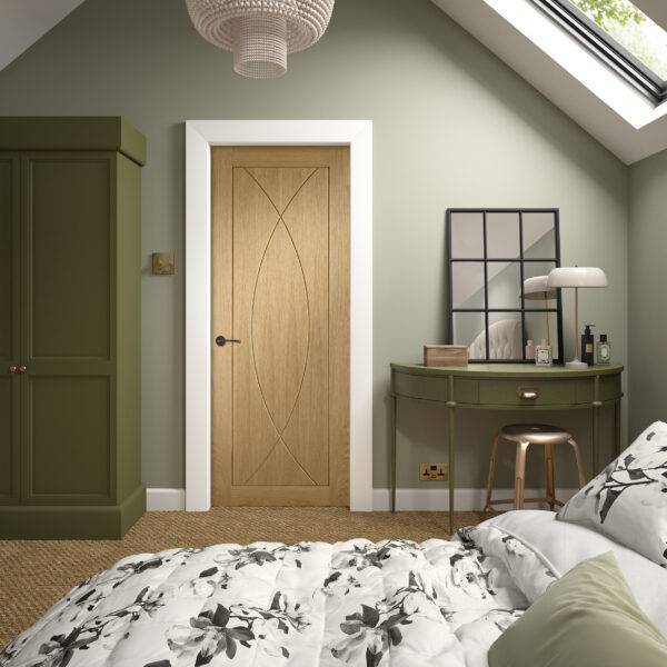 Bedroom interior with wooden door, green wall, and decorative elements.