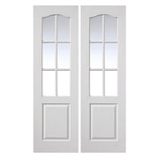 Pair of white interior doors with glass panels on a white background