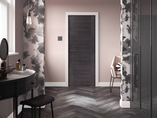Modern interior design with a dark wooden door, floral wallpaper, and a vanity setup.