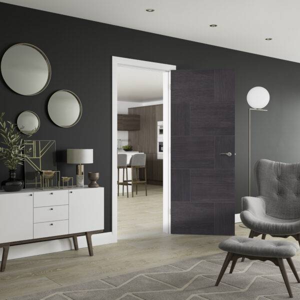 Modern interior design with dark gray walls, a gray armchair, and a white cabinet.