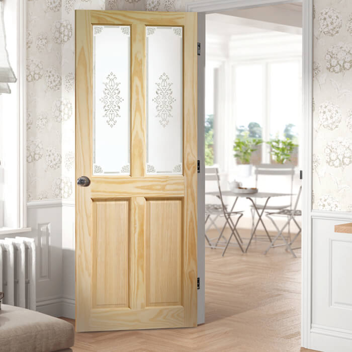 Wooden door with glass panels in a room with floral wallpaper and a dining area.