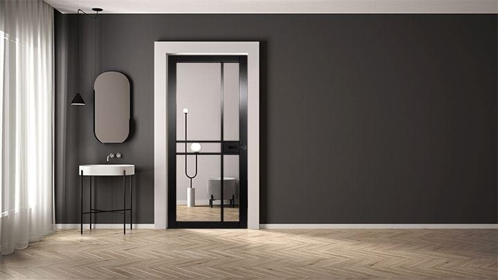 Modern interior design with a dark gray wall, wooden floor, and a stylish mirror.