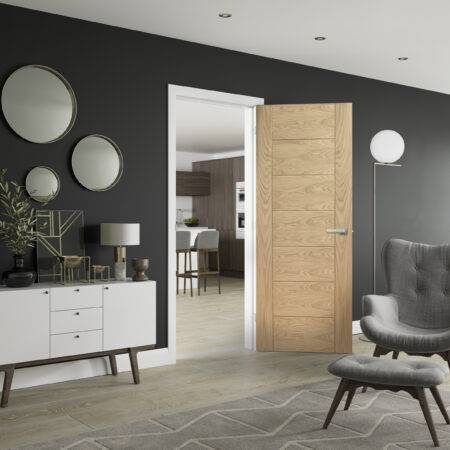 Modern interior design with wooden door, gray chair, and dark walls.