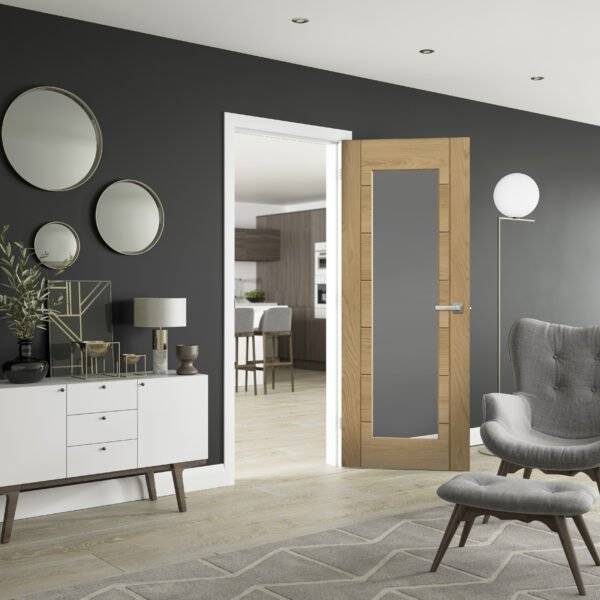 Modern interior design with gray walls, wooden door, and gray furniture.