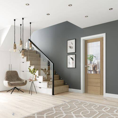 Modern interior design of a staircase and living area with gray walls, wooden door, and decorative elements.
