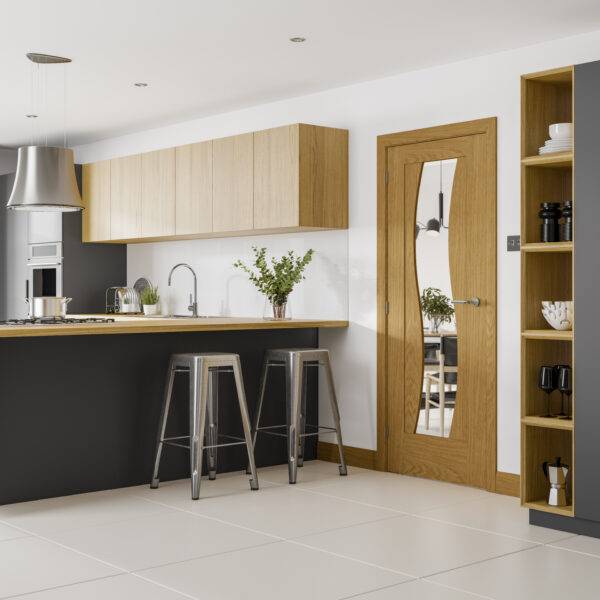 Modern kitchen with wooden cabinets, a door, and bar stools.