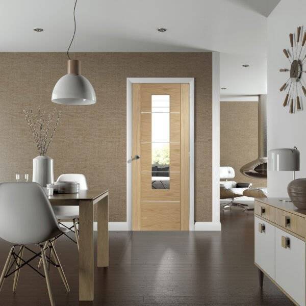 Modern interior with a wooden door, dining table, and chairs.