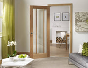 Wooden interior door with glass panels in a living room setting.