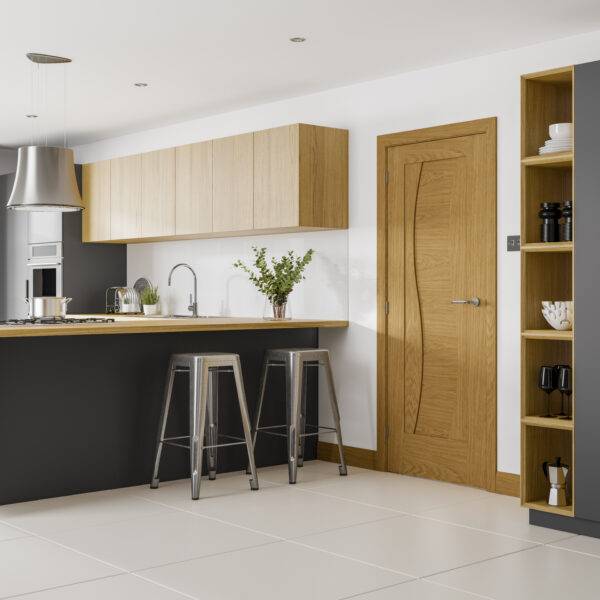 Modern kitchen with wooden cabinets, a door, and a shelf.