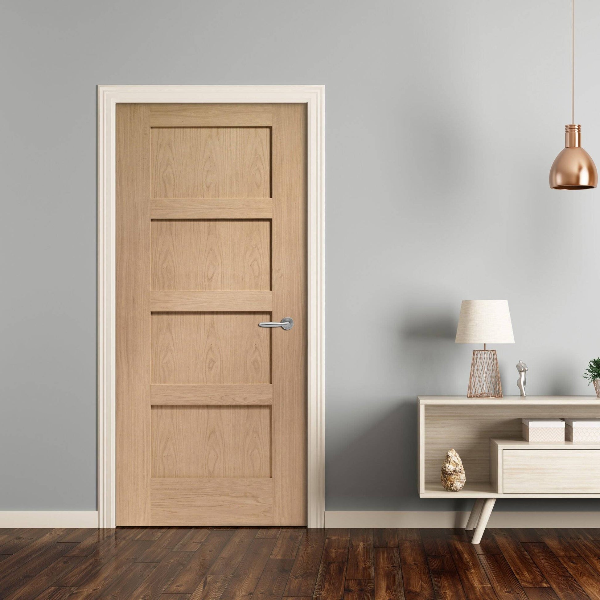 Wooden door in a room with a lamp and shelf against a gray wall.