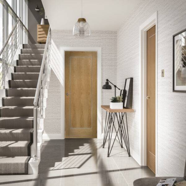 Modern interior with wooden doors, staircase, and minimal decor.