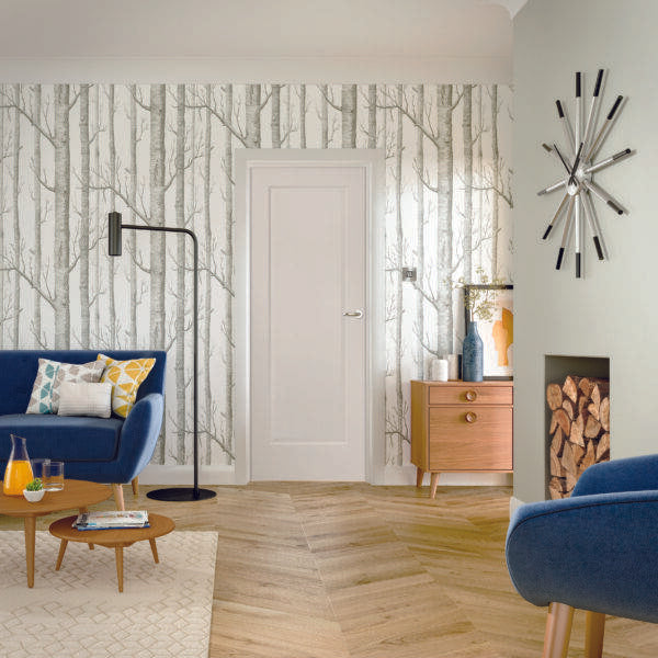 Modern living room with blue chairs, a wooden coffee table, and decorative elements.