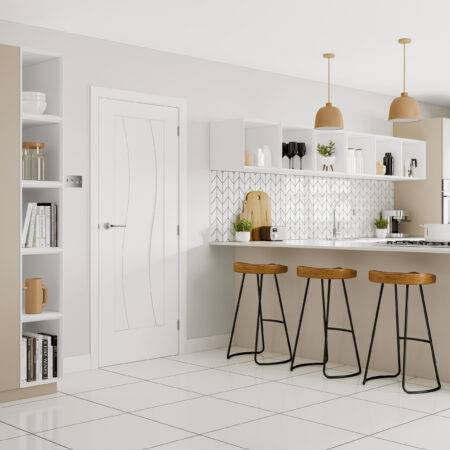 Modern kitchen with white cabinets, marble countertop, and wooden stools.