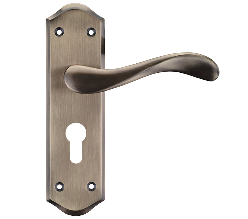 Bronze door handle with keyhole on a white background
