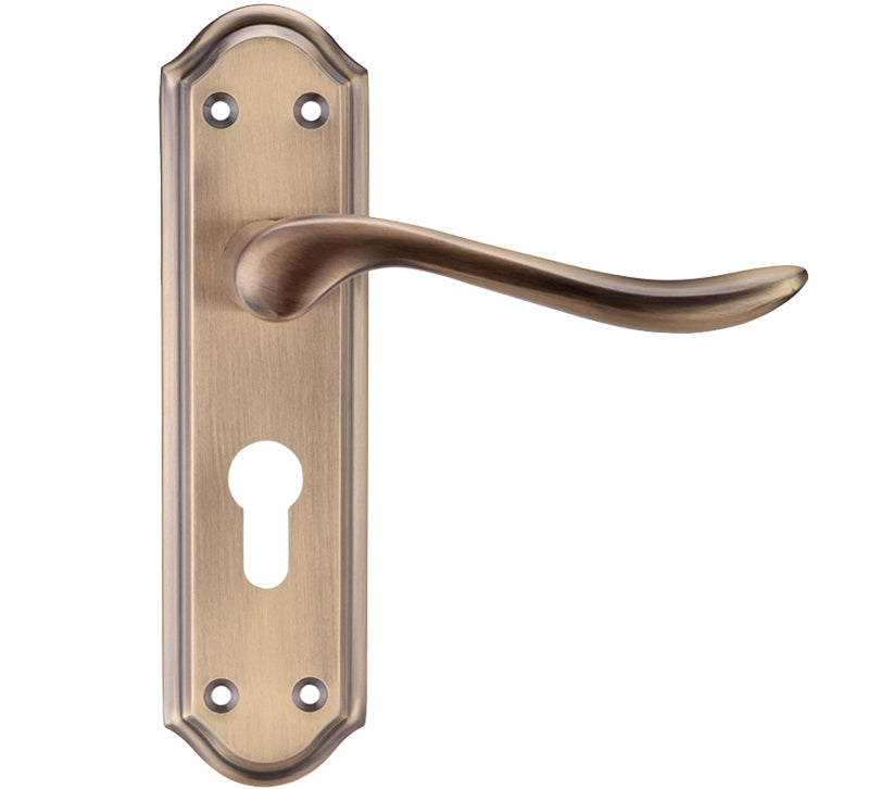 Brass door handle with keyhole on a white background