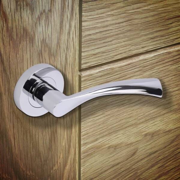 Chrome door handle on a wooden door