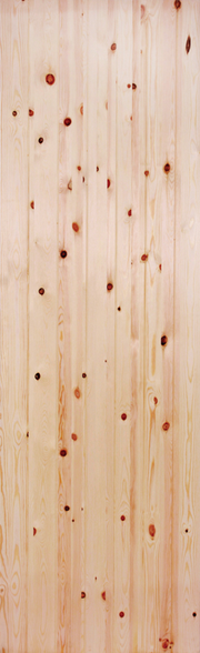 Close-up of a unfinished redwood door with visible grain and knots