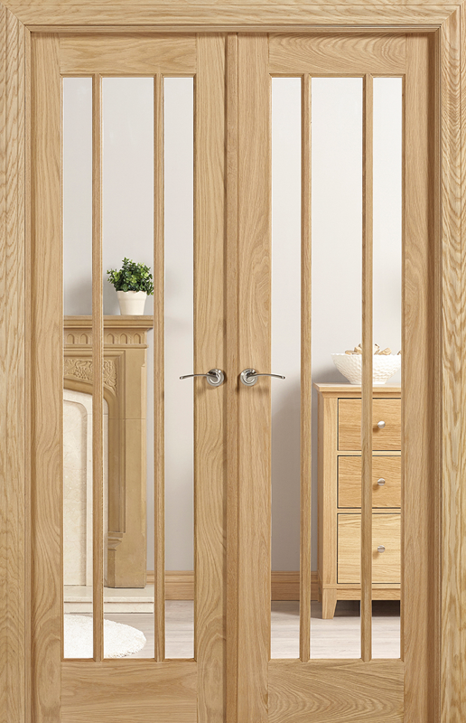Wooden interior doors with glass panels in a room setting.