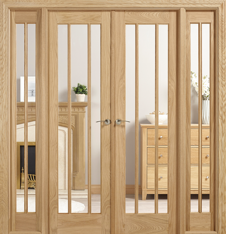 Wooden interior door with glass panels in a room with furniture.
