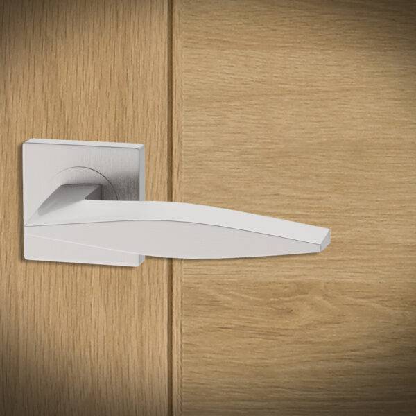 Modern door handle on a wooden door
