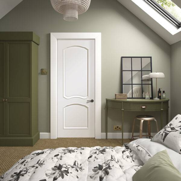 Neatly decorated bedroom with a bed, wardrobe, and desk.