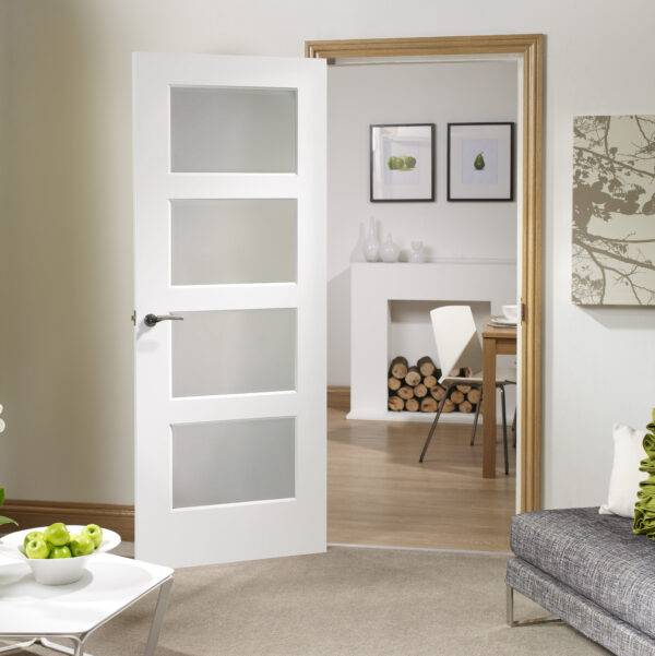 White interior door with glass panels in a home setting