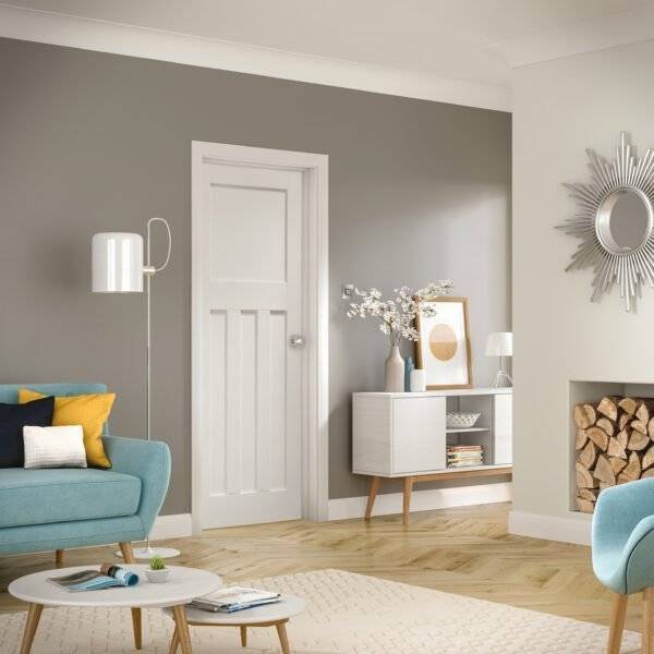 Modern living room with gray walls, a white door, and decorative elements.