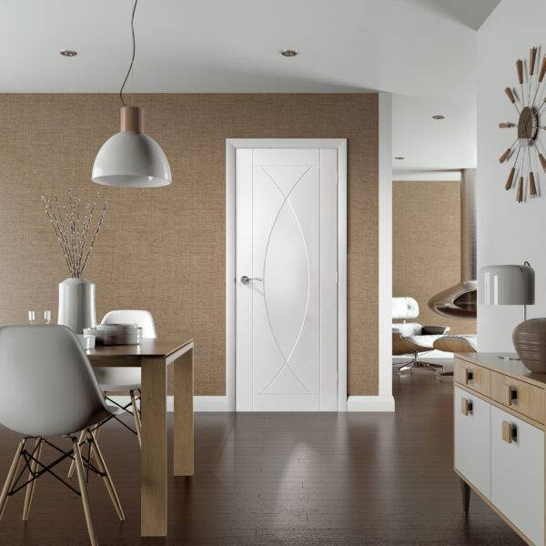 Modern interior with a white door featuring a decorative glass panel, dining table, and chairs.