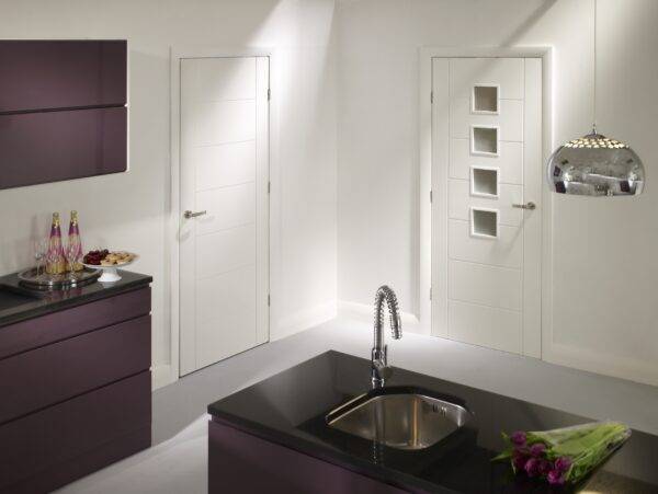 Modern kitchen with black countertop, sink, and purple cabinets.