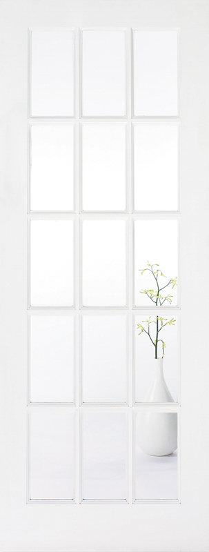 White door with glazed panels and a vase with branches on a white surface.