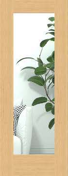 Glass door with wooden frame featuring a plant reflection