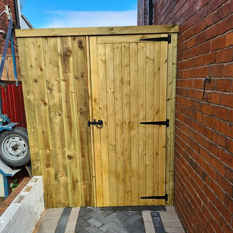 Wooden gate with metal handles on a brick wall background